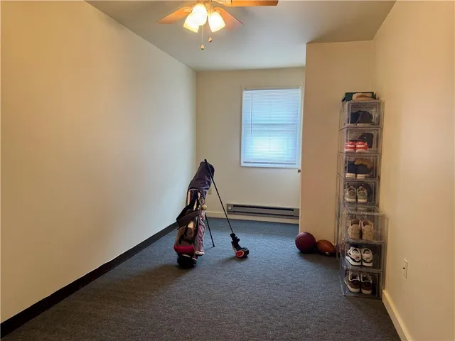 a view of room with lounge chair and windows