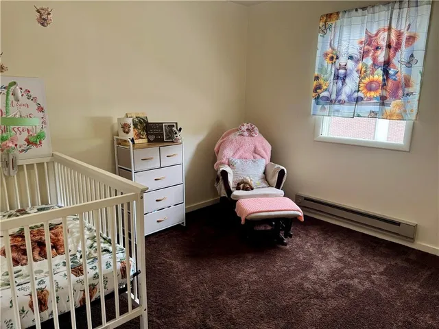 a bedroom with furniture and baby crib