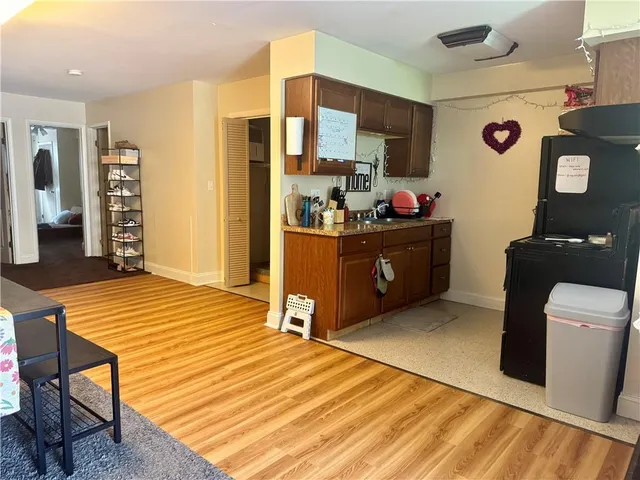 a kitchen with stainless steel appliances kitchen island granite countertop a table and chairs in it
