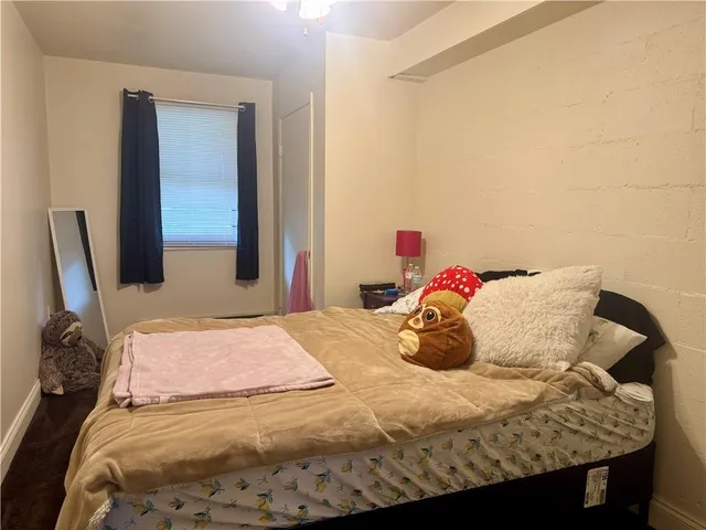 a bedroom with a bed and dresser