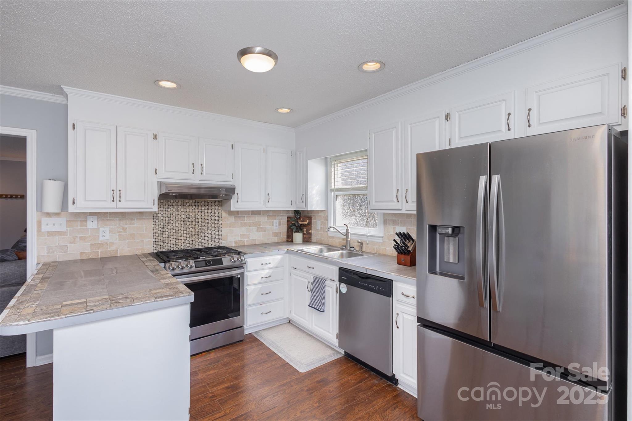 110 Weeping Willow Way Gastonia, NC 28052 - Photo 11 of 28 a kitchen with stainless steel appliances granite countertop a refrigerator stove a sink and white cabinets