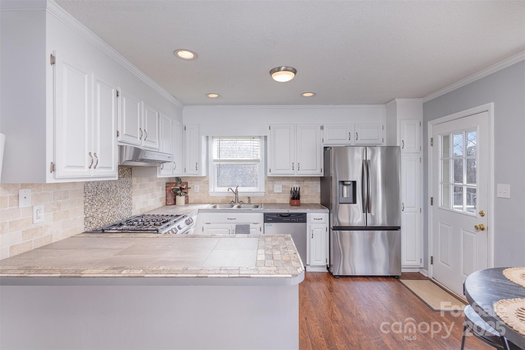 110 Weeping Willow Way Gastonia, NC 28052 - Photo 12 of 28 a kitchen with stainless steel appliances granite countertop a refrigerator sink and white cabinets