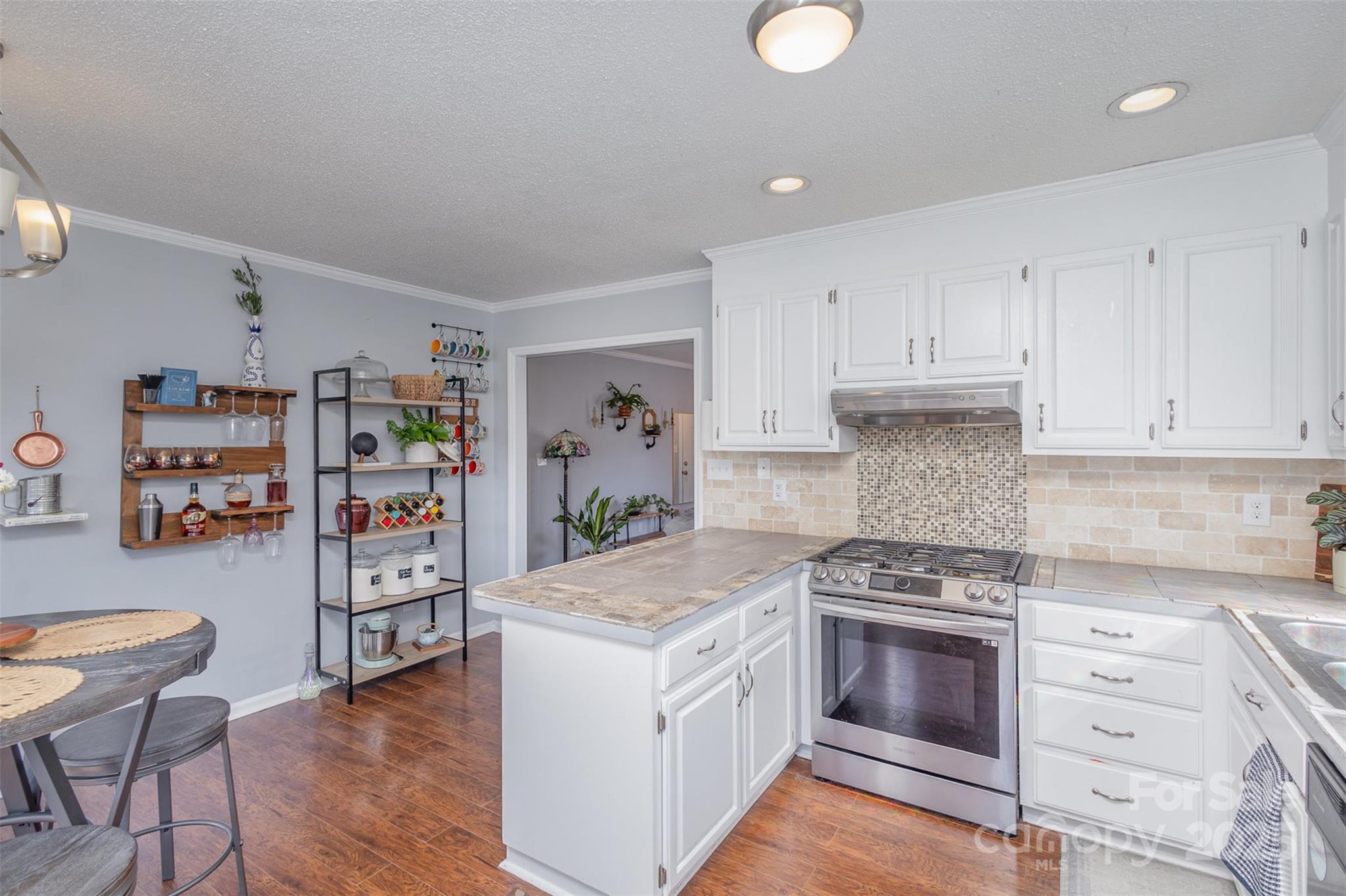 110 Weeping Willow Way Gastonia, NC 28052 - Photo 10 of 28 a kitchen with stainless steel appliances a stove a cabinets and wooden floor