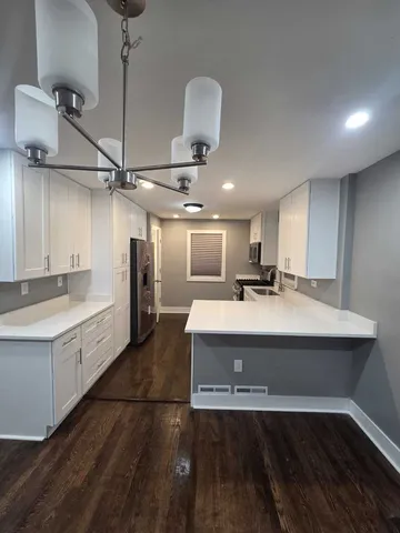 a bathroom with a sink a toilet a shower and a mirror