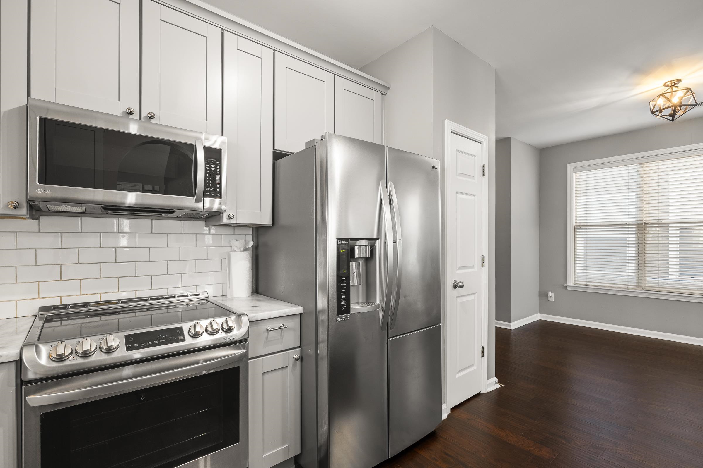 1323 Island Ridge Drive Memphis, TN 38103 - Photo 12 of 29 a kitchen with stainless steel appliances a stove a refrigerator and a microwave