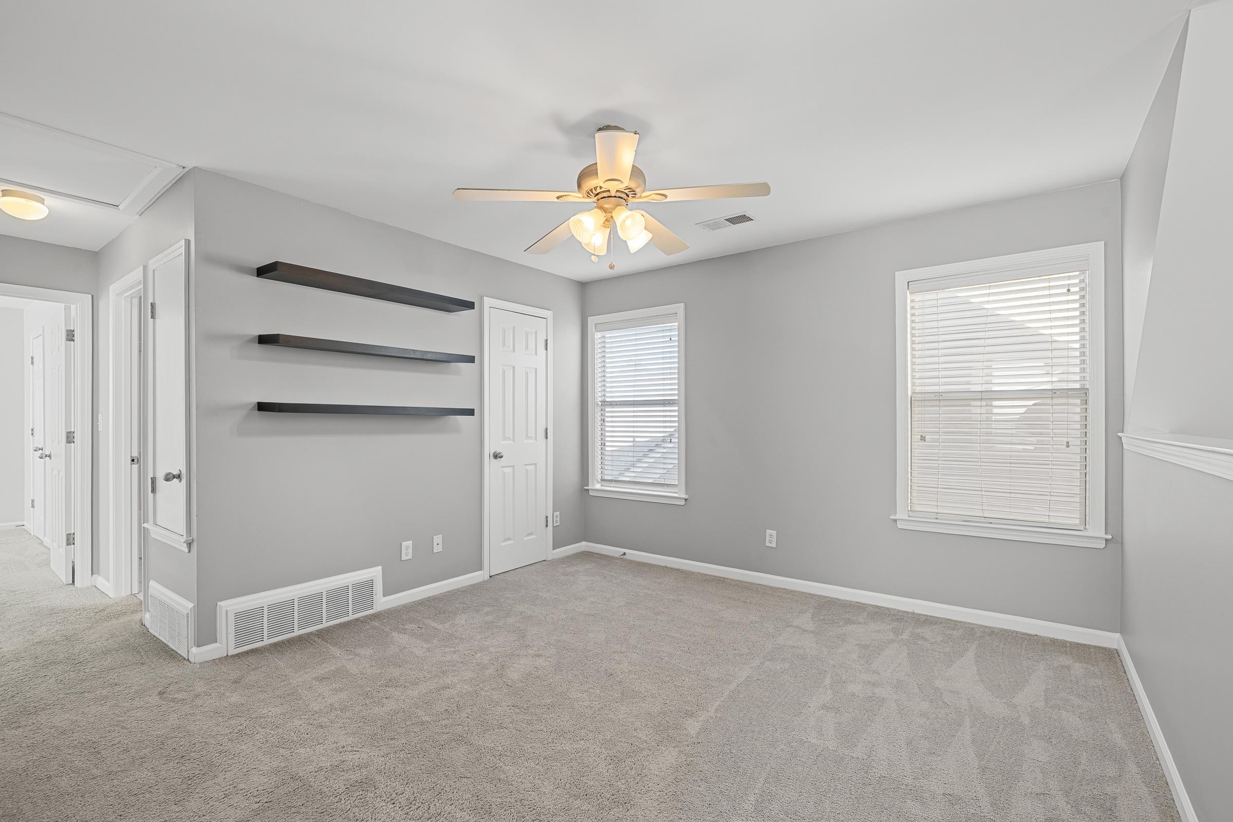 1323 Island Ridge Drive Memphis, TN 38103 - Photo 22 of 29 an empty room with windows and fan