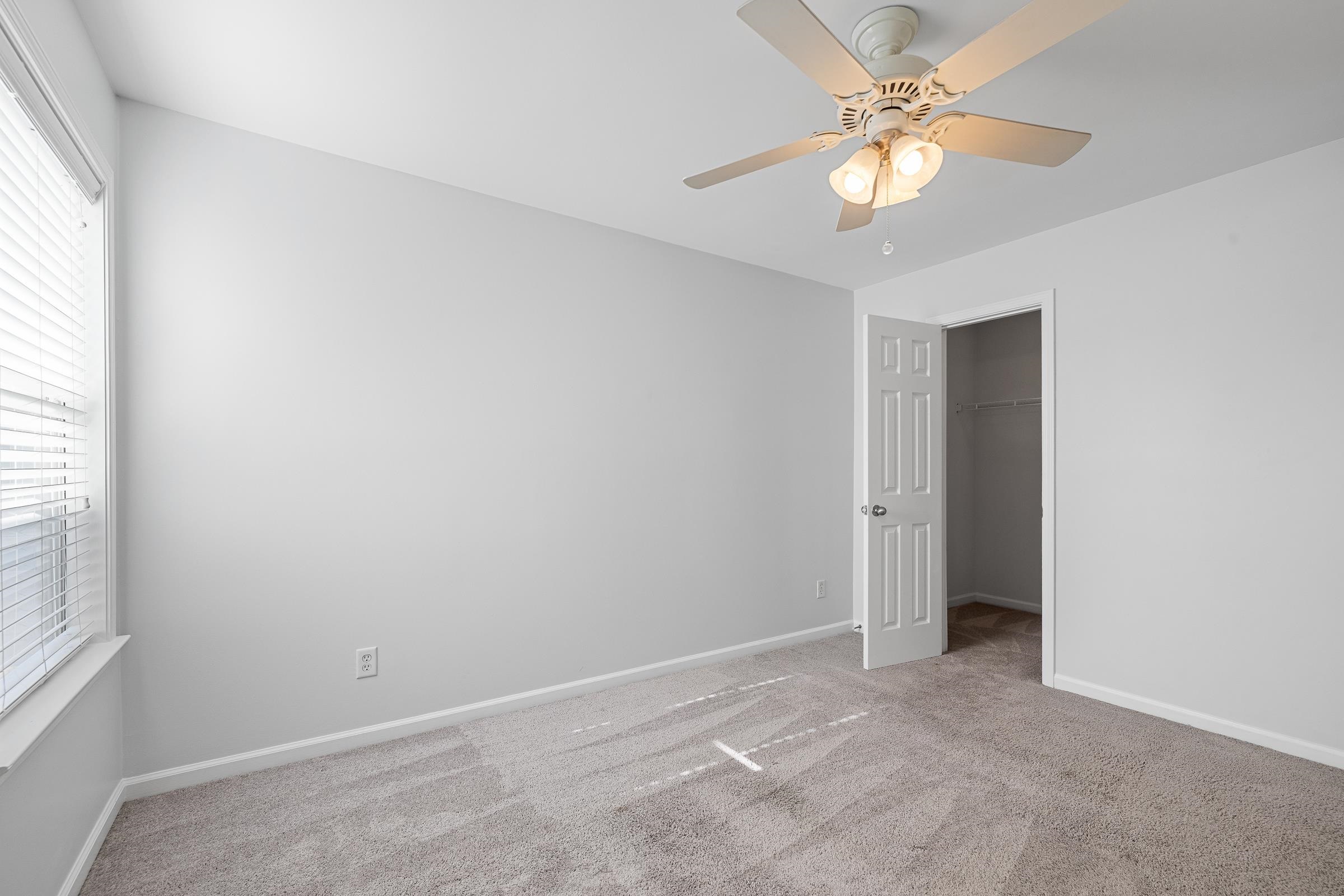 1323 Island Ridge Drive Memphis, TN 38103 - Photo 25 of 29 an empty room with a window and a fan