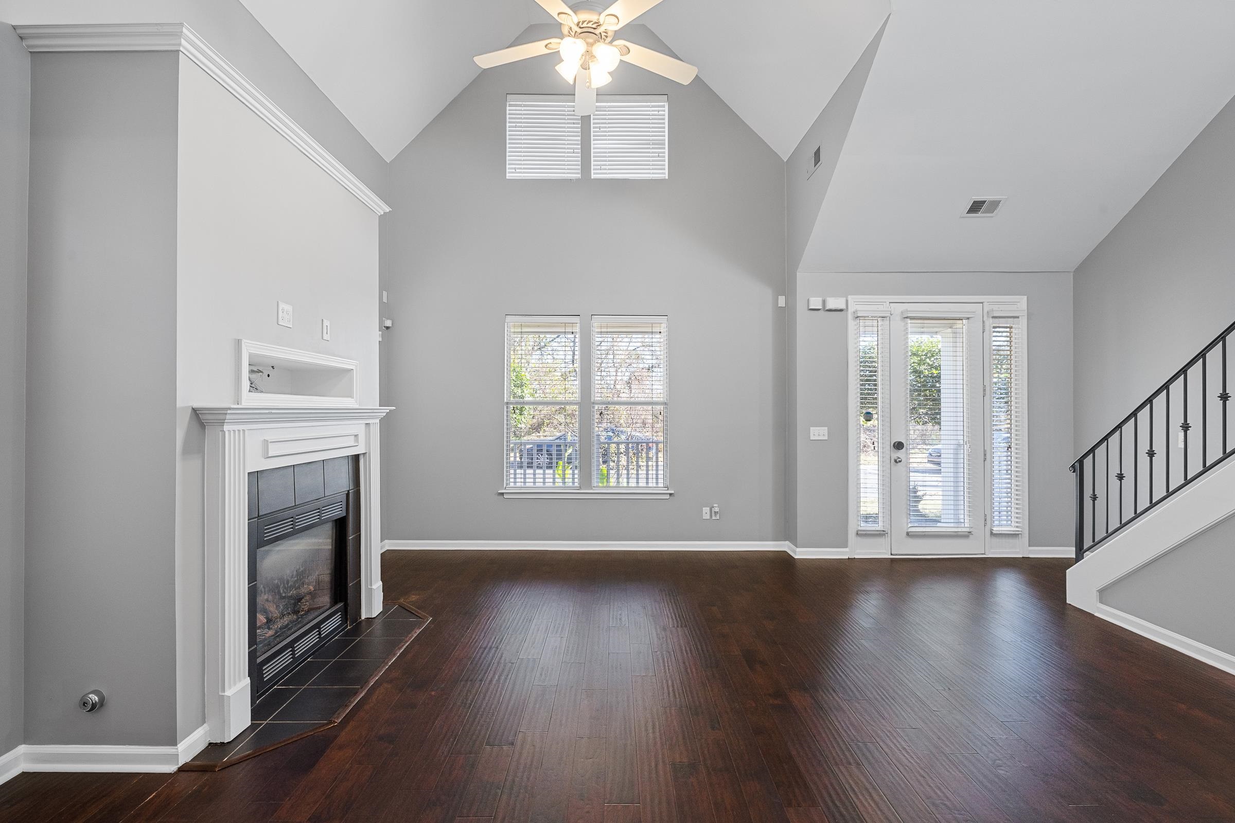 1323 Island Ridge Drive Memphis, TN 38103 - Photo 5 of 29 an empty room with wooden floor fan and windows