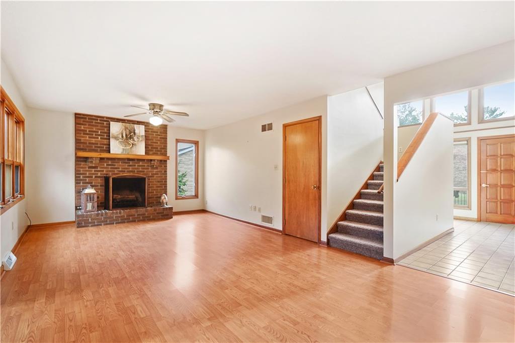 195 Shafer Road Coraopolis, PA 15108 - Photo 5 of 25 Family Room with gas start fireplace is brightened by the open two story staircase with walls of windows in the entry.