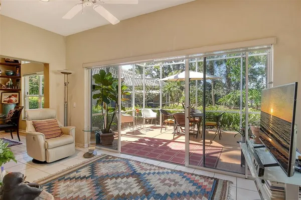 a dining room with furniture and a potted plant