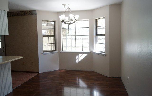505 Ridge Lake Road Crestview, FL 32536 - Photo 3 of 18 an empty room with wooden floor and windows