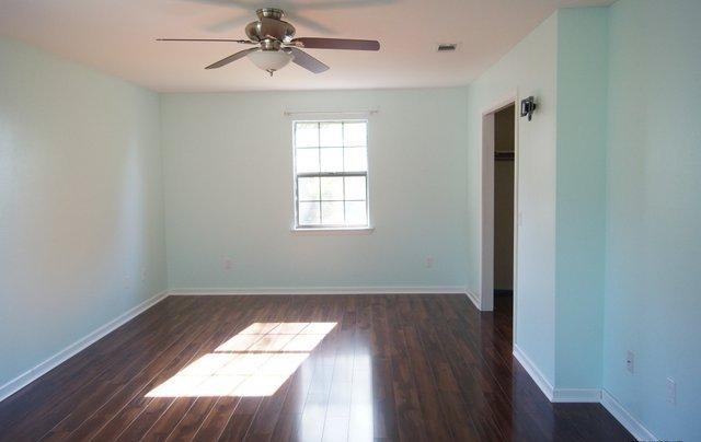 505 Ridge Lake Road Crestview, FL 32536 - Photo 6 of 18 wooden floor in an empty room with a window