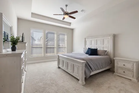 a bedroom with a large bed and a large window