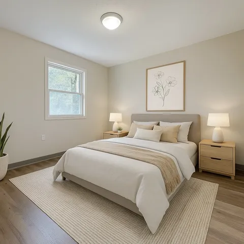 a bedroom with a bed and a painting on the wall