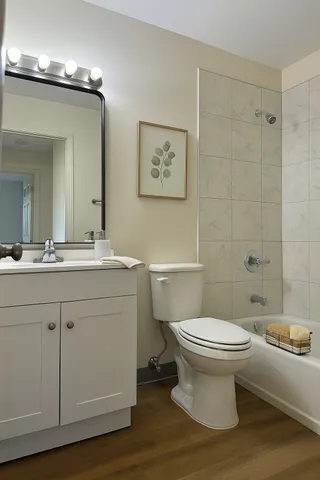 a bathroom with a sink toilet and shower