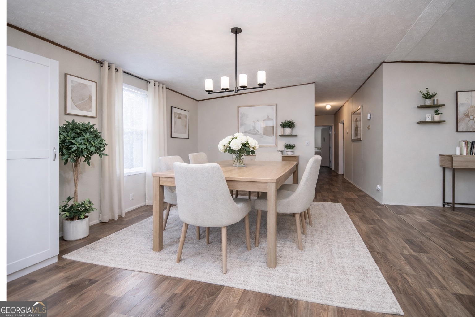 450 Glenloch Road Roopville, GA 30170 - Photo 15 of 38 a dining room with furniture potted plants and wooden floor