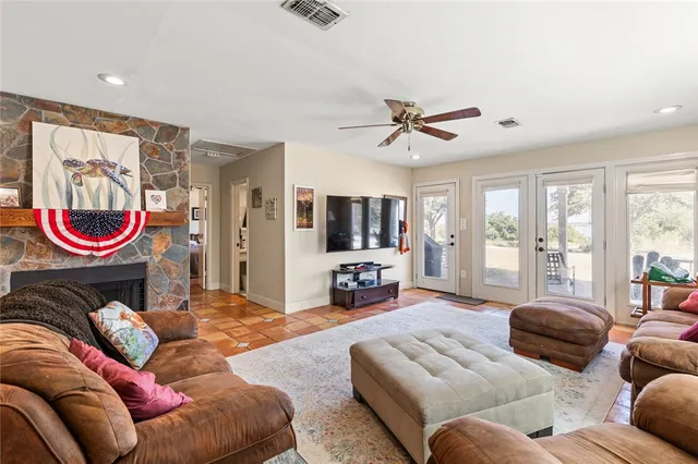 a living room with furniture ceiling fan and a rug