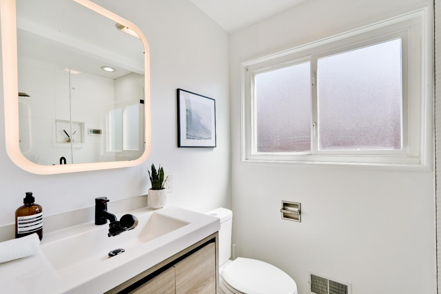 1755 Ravizza Avenue Santa Clara, CA 95051 - Photo 20 of 36 a bathroom with a sink mirror and toilet