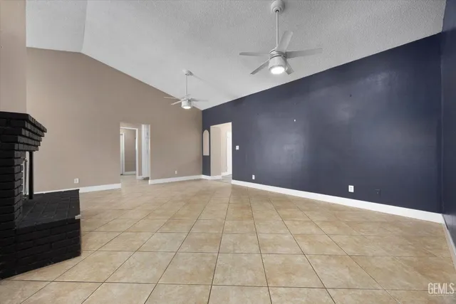 a view of a kitchen with an empty space and a window