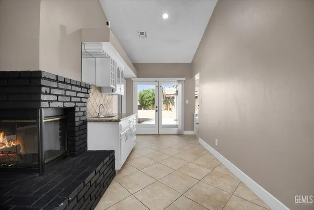 a large kitchen with stainless steel appliances kitchen island a large counter top and a sink