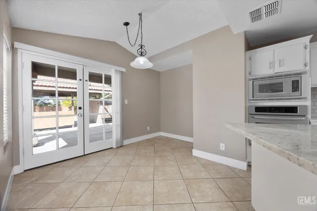a large kitchen with stainless steel appliances granite countertop a sink and cabinets