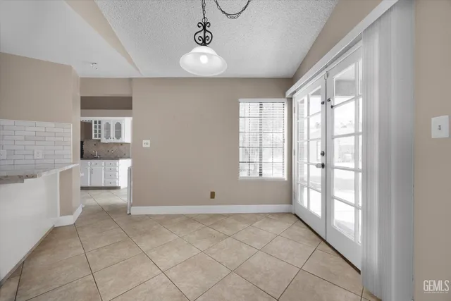 a large kitchen with stainless steel appliances granite countertop a sink and cabinets