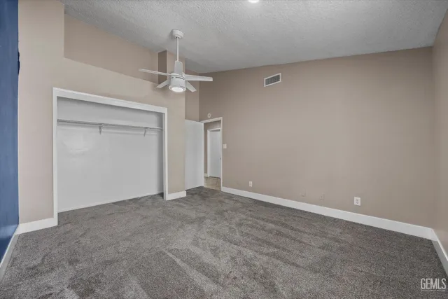 a view of a fence of a house with a tree