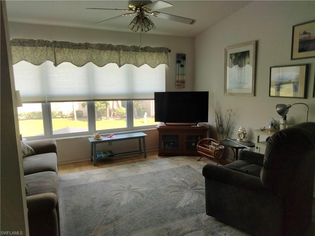 3535 Antarctic Circle, Unit 2302 Naples, FL 34112 - Photo 4 of 14 a living room with furniture and a flat screen tv