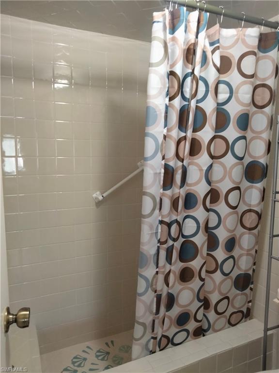 3535 Antarctic Circle, Unit 2302 Naples, FL 34112 - Photo 7 of 14 a bathroom with a shower curtain