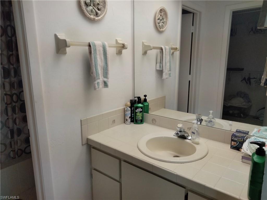 3535 Antarctic Circle, Unit 2302 Naples, FL 34112 - Photo 8 of 14 a bathroom with a sink and a mirror