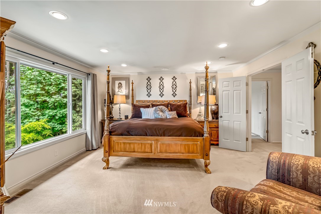 21518 30th Avenue Southeast Bothell, WA 98021 - Photo 21 of 40 a bedroom with a bed and glass window