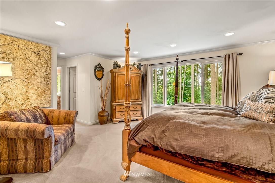 21518 30th Avenue Southeast Bothell, WA 98021 - Photo 22 of 40 a bedroom with a bed and glass window