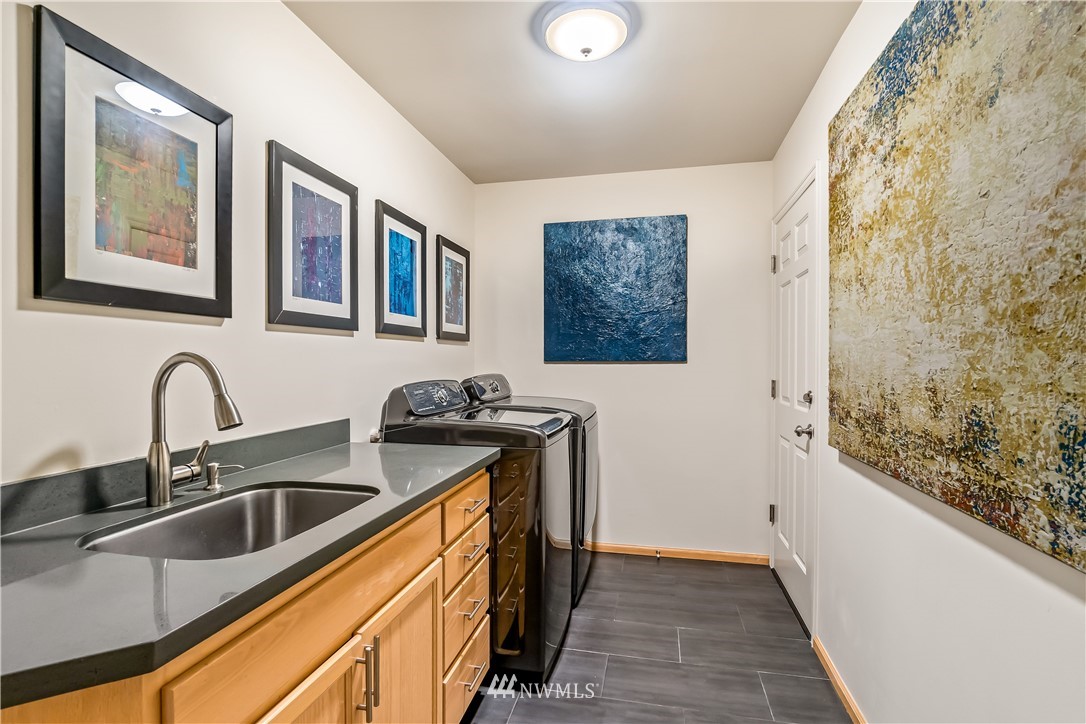 21518 30th Avenue Southeast Bothell, WA 98021 - Photo 31 of 40 a kitchen with stainless steel appliances granite countertop a sink and a refrigerator
