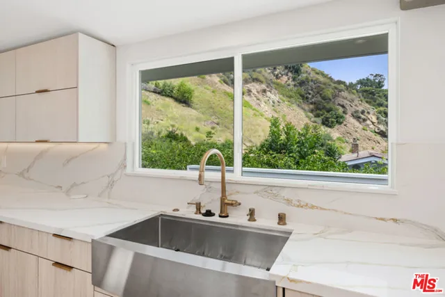 a sink sitting next to a window