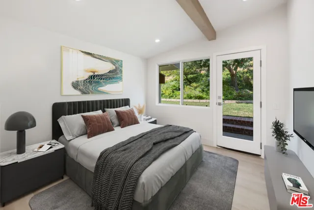 a bedroom with bed and a window