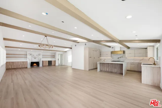 a view of a kitchen with furniture and wooden floor