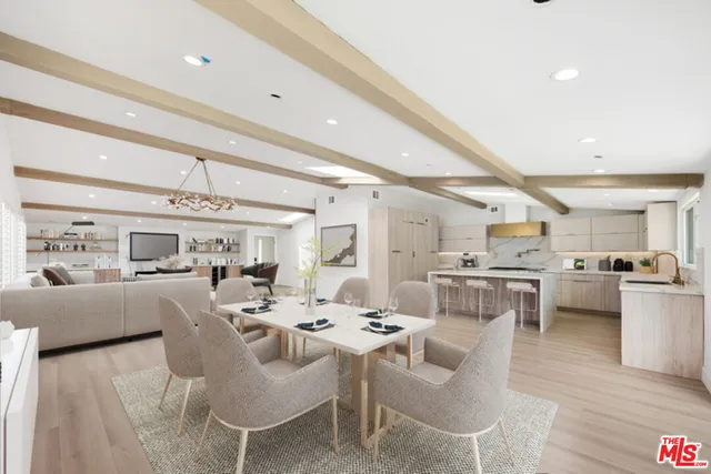 a living room with lots of furniture and kitchen view