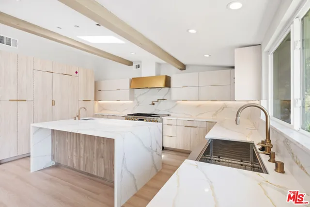 a kitchen with a stove a sink and a refrigerator