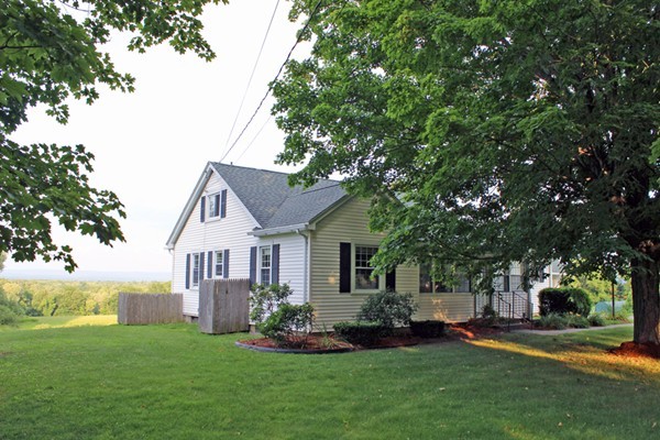 168 Chestnut Plain Road Whately, MA 01093 - Photo 1 of 28 a front view of a house with a garden and trees