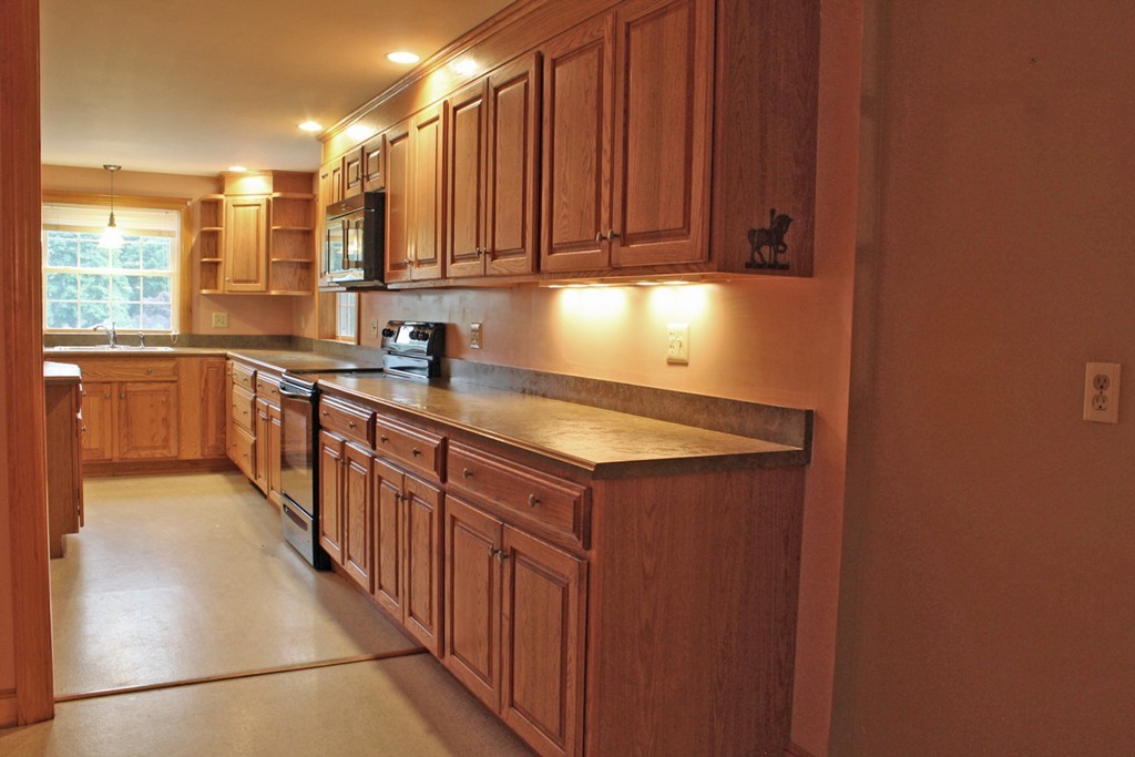168 Chestnut Plain Road Whately, MA 01093 - Photo 7 of 28 a kitchen with stainless steel appliances granite countertop a sink stove and cabinets