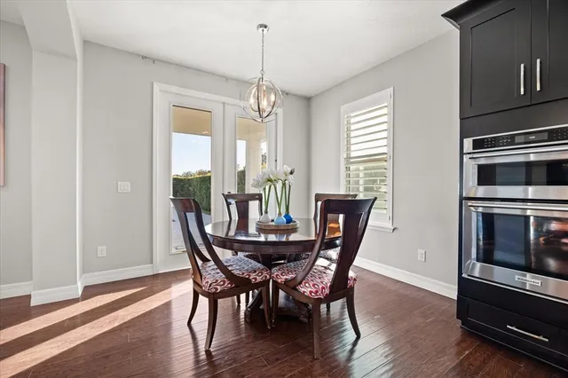 a kitchen with stainless steel appliances kitchen island granite countertop a kitchen island hardwood floor and a sink