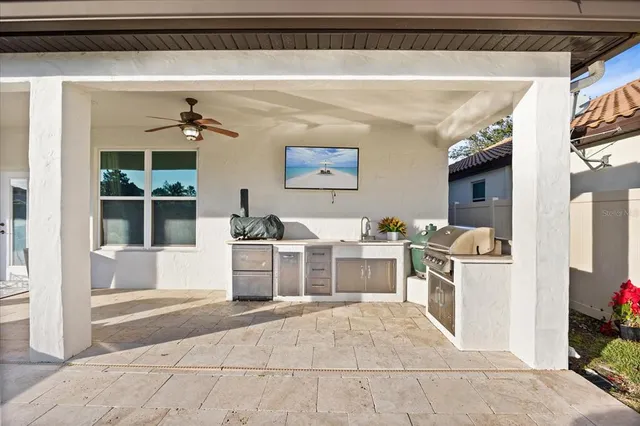 a view of a patio with couches table and chairs with wooden floor and fence