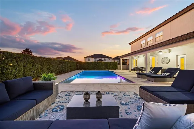 a view of swimming pool with sitting area