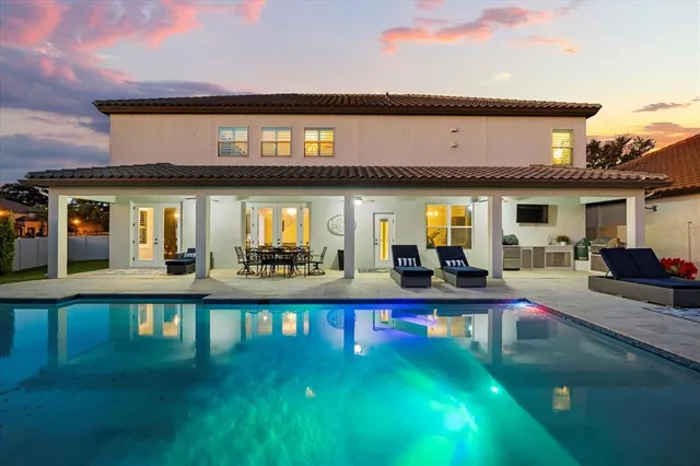a view of a house with backyard porch and sitting area