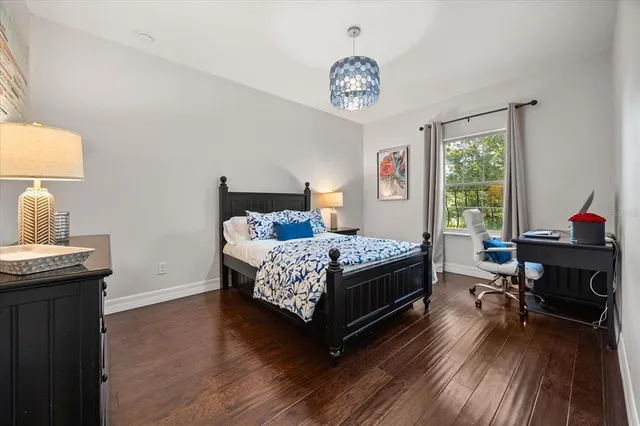 a bedroom with a bed and a chandelier