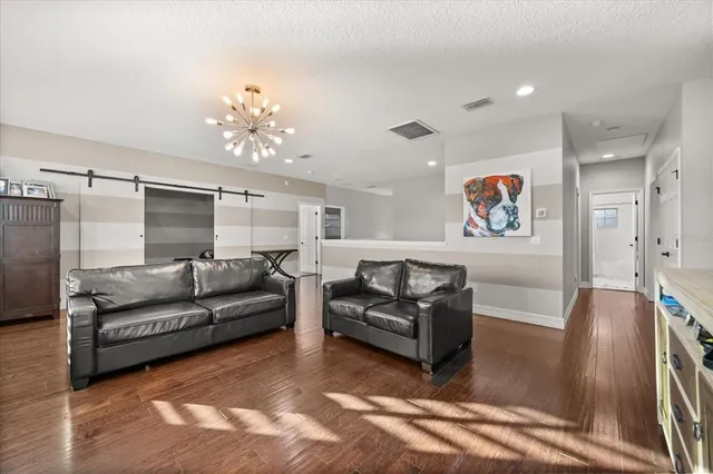 a living room with furniture with kitchen view