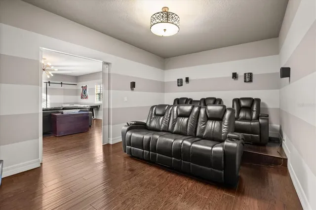 a view of a patio with couches dining table and chairs with a barbeque grill