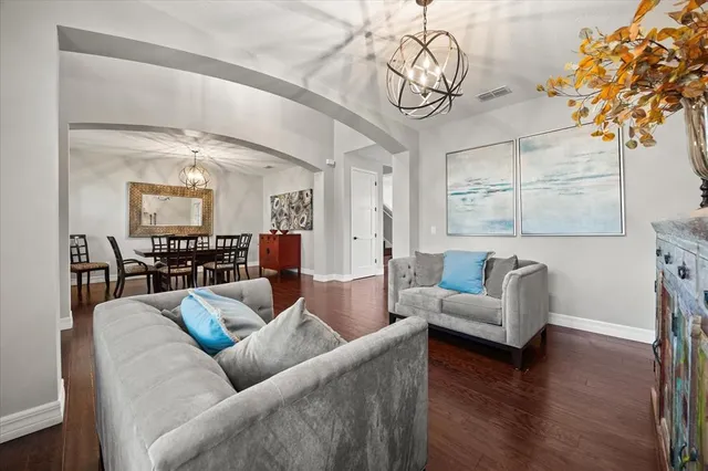 a living room with fireplace furniture and a wooden floor