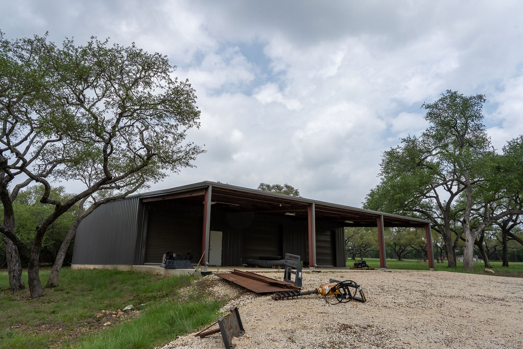 426 Mill Run New Braunfels, TX 78132 - Photo 40 of 40 a view of patio with a table and chairs under an umbrella