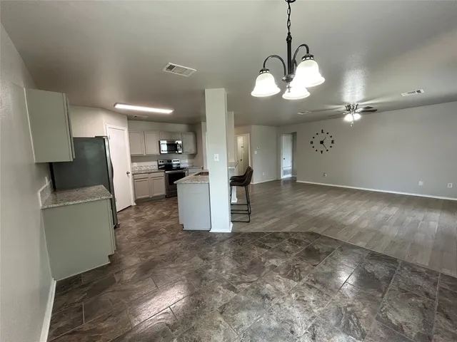 a bathroom with a granite countertop toilet sink and shower